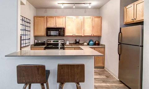 a kitchen with a counter top and a refrigerator