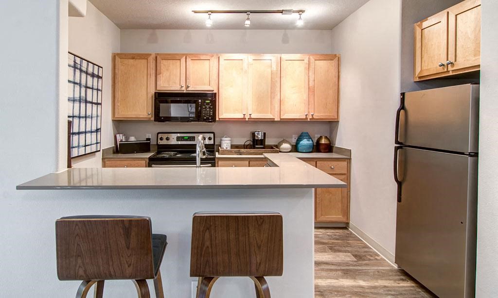 a kitchen with a counter top and a refrigerator