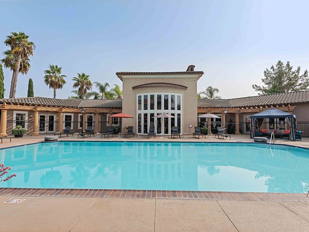 a swimming pool with a building in the background