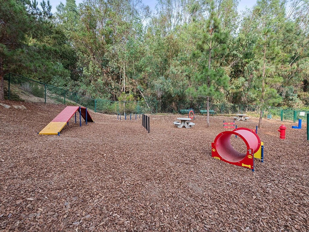 a park with a playground and a tent