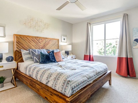 Bedroom with large window and ceiling fan