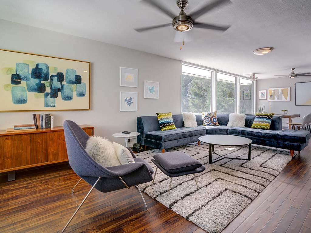 a living room with furniture and a ceiling fan