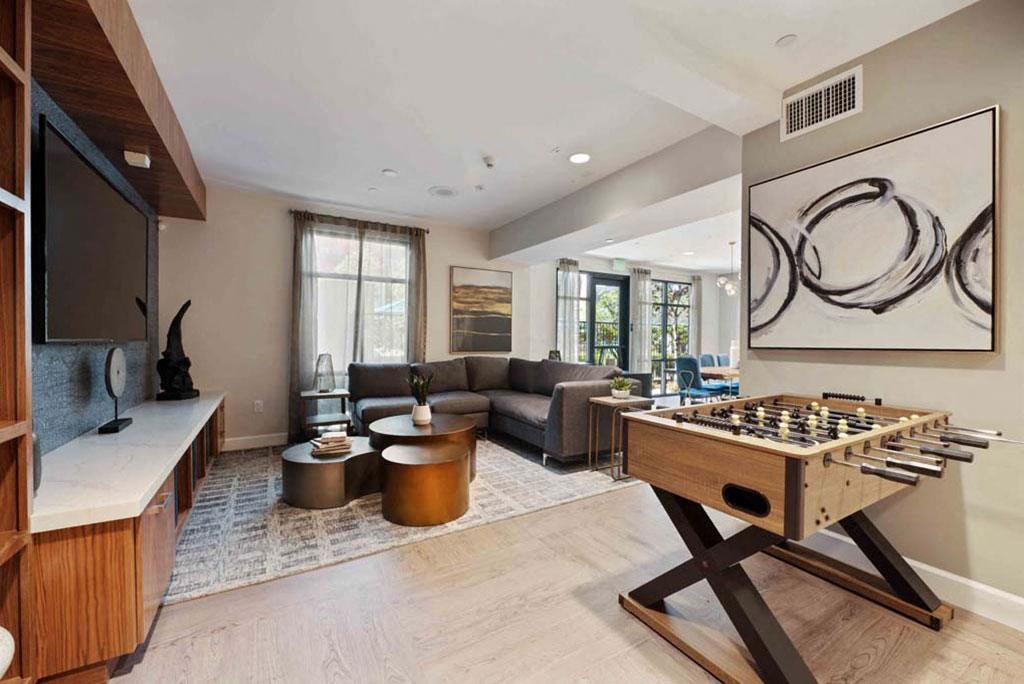 a games room with a foosball table and a tv