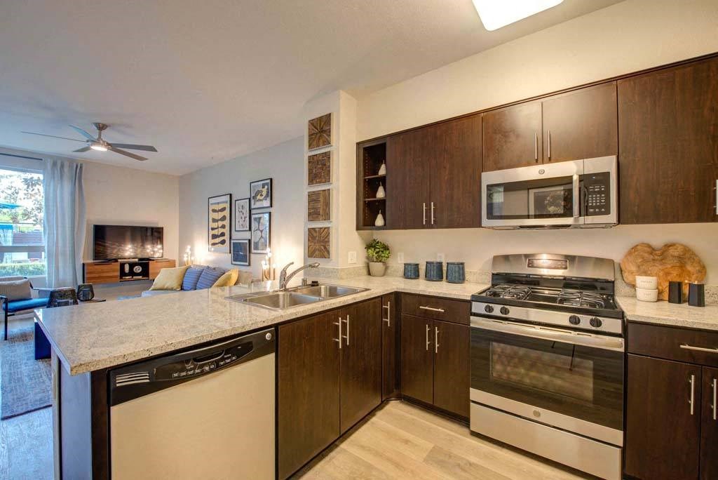 a kitchen with a stove microwave and a sink