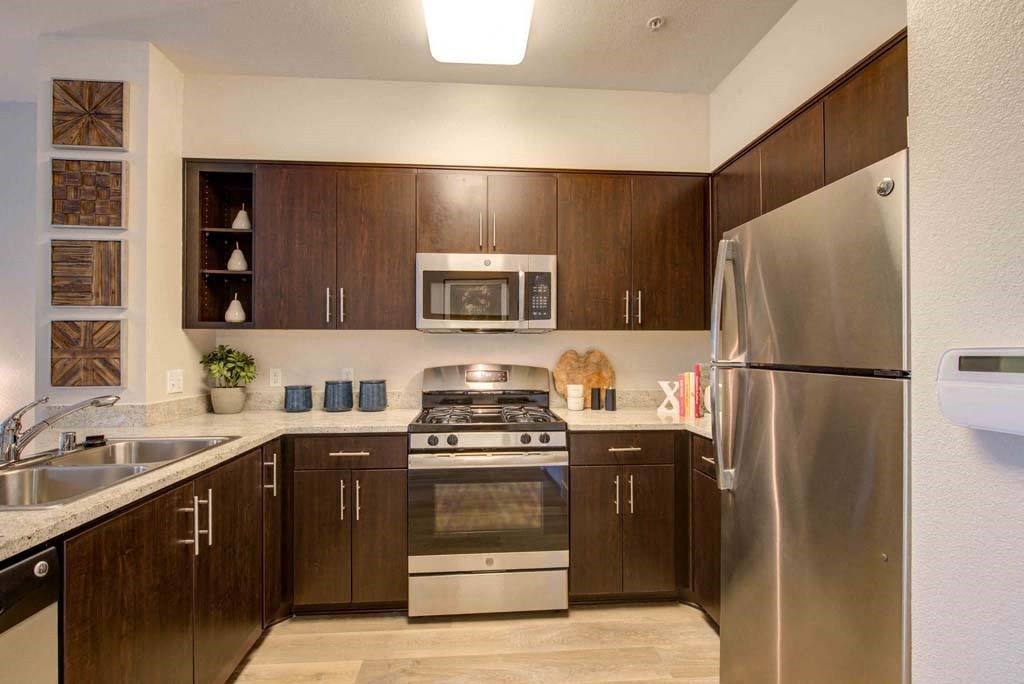 a kitchen with stainless steel appliances and wooden cabinets