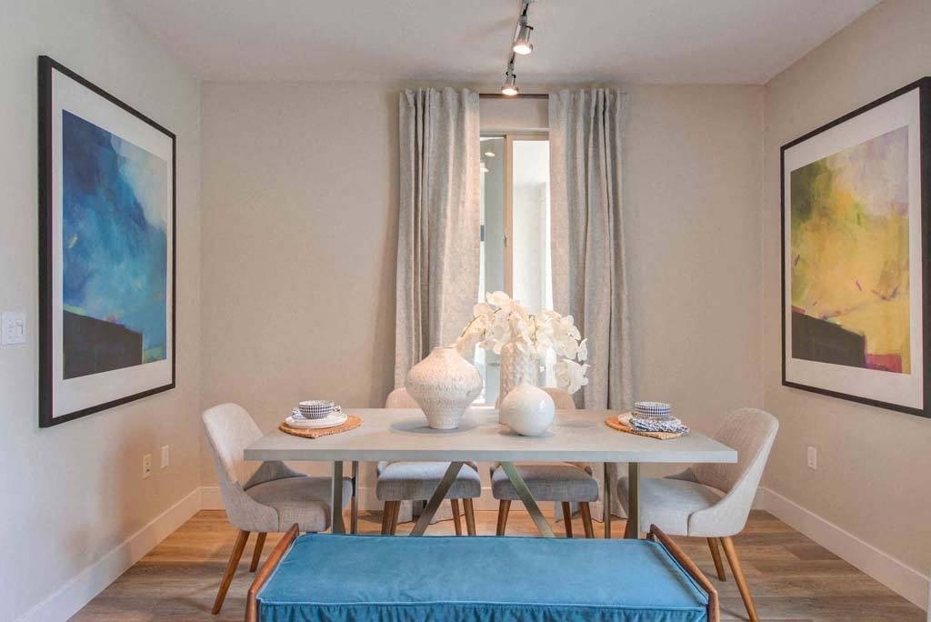 a dining room with a table and chairs