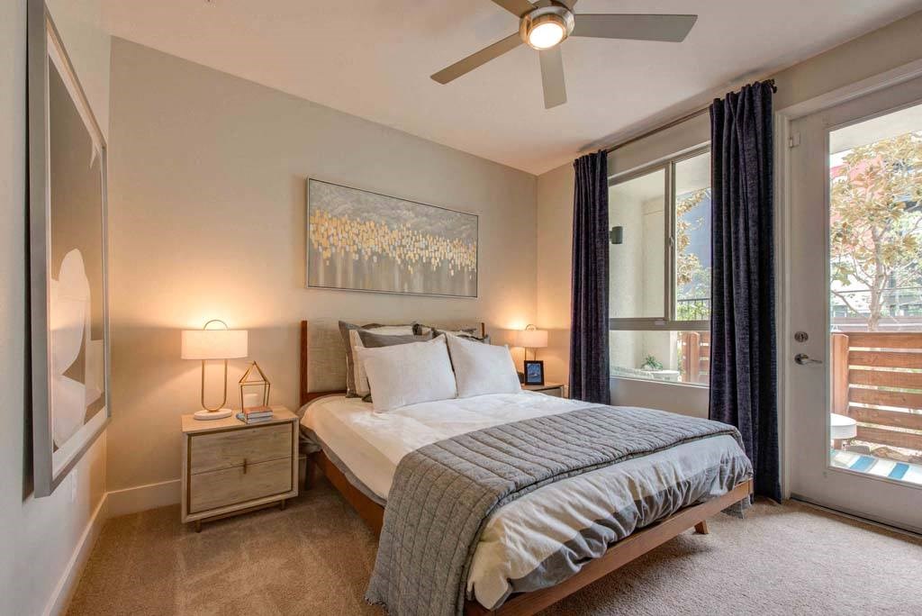 a bedroom with a bed and a ceiling fan