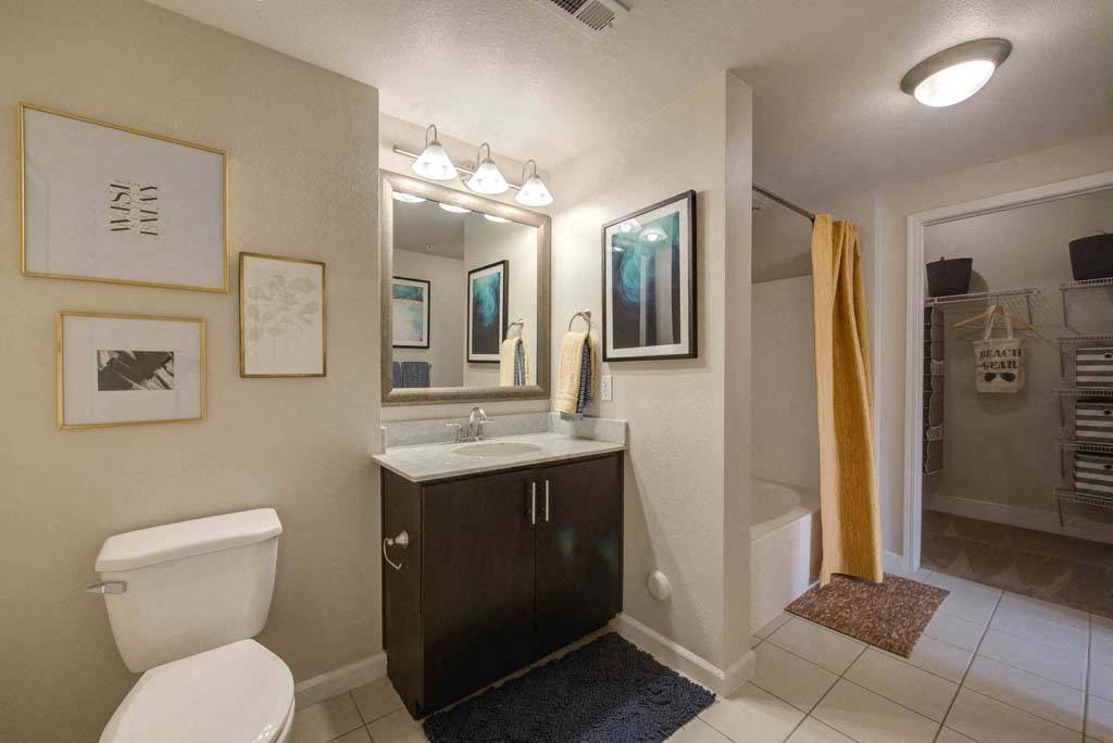 a bathroom with a toilet sink and a mirror