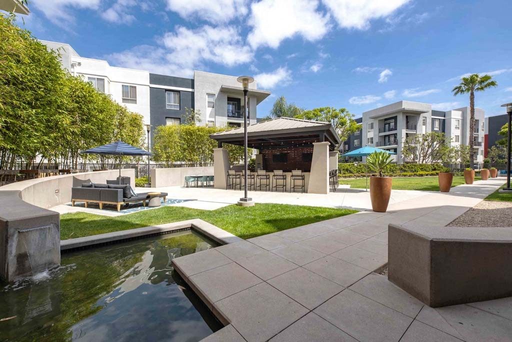 a patio with a pool and a gazebo in a building
