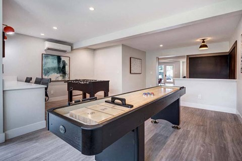 a game room with a pool table and a television