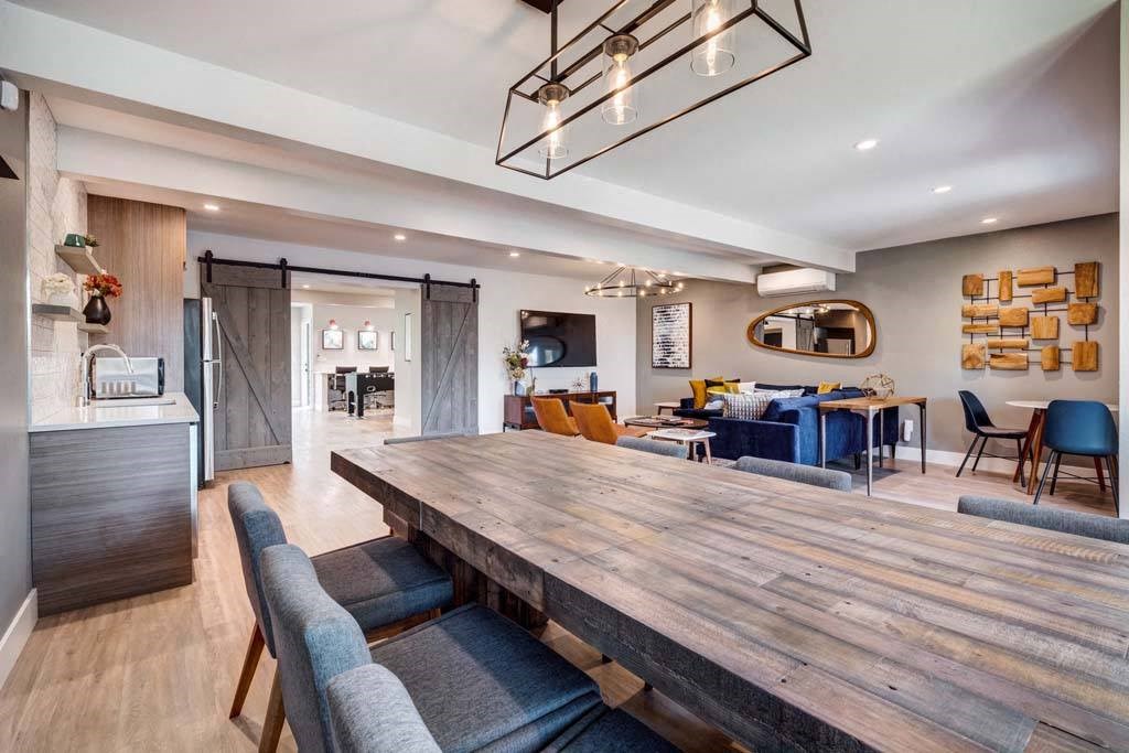 a dining room and living room with a wooden table