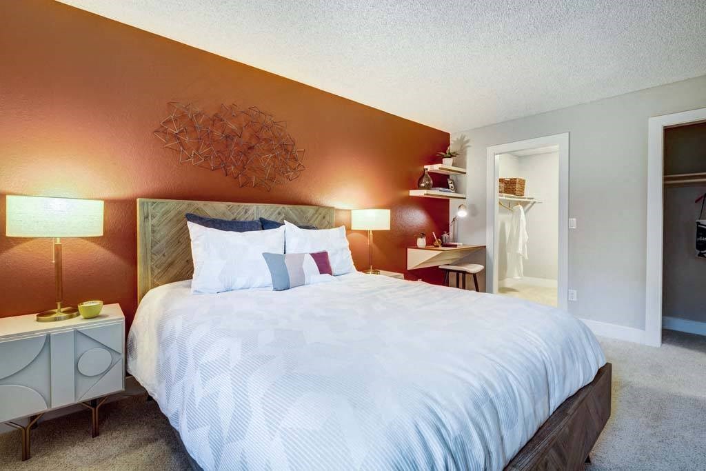 a bedroom with a large bed and a closet