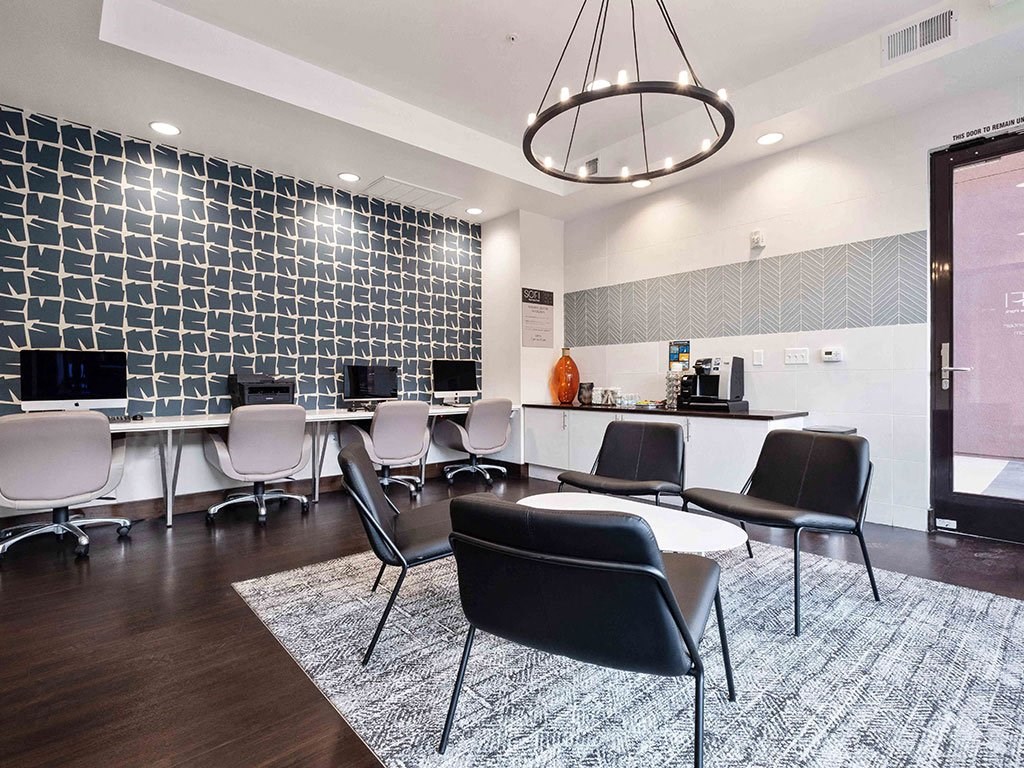 a conference room with desks and chairs and a table