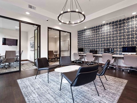 a conference room with desks and chairs and a rug