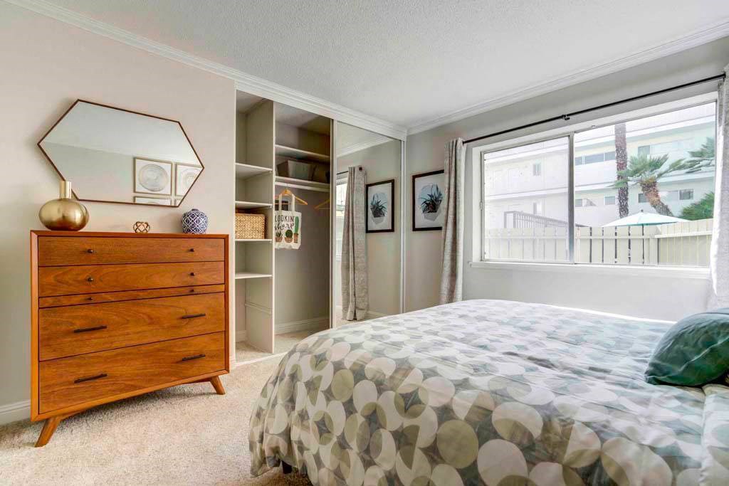 a bedroom with a bed and a dresser and a window