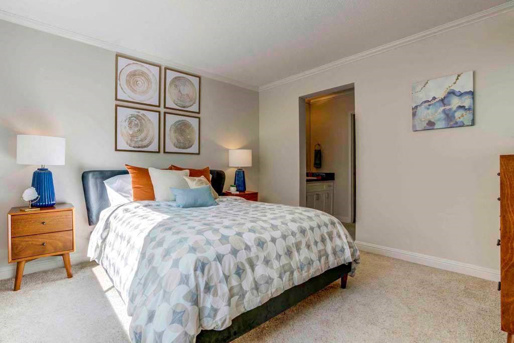 a bedroom with a bed and some pictures on the wall