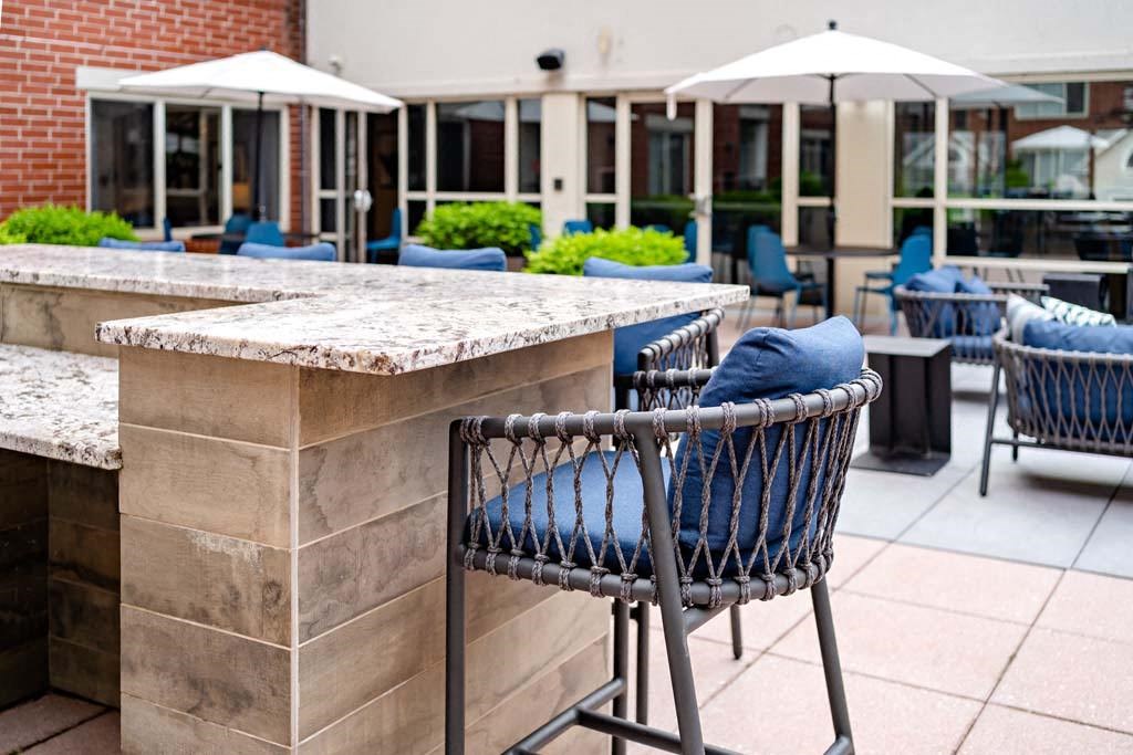 a bar with chairs and umbrellas on a patio