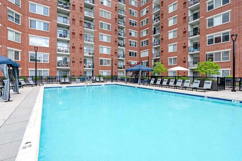 a swimming pool in front of an apartment building