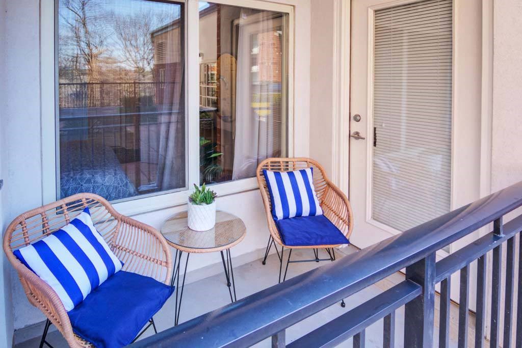 a balcony with two chairs and a table
