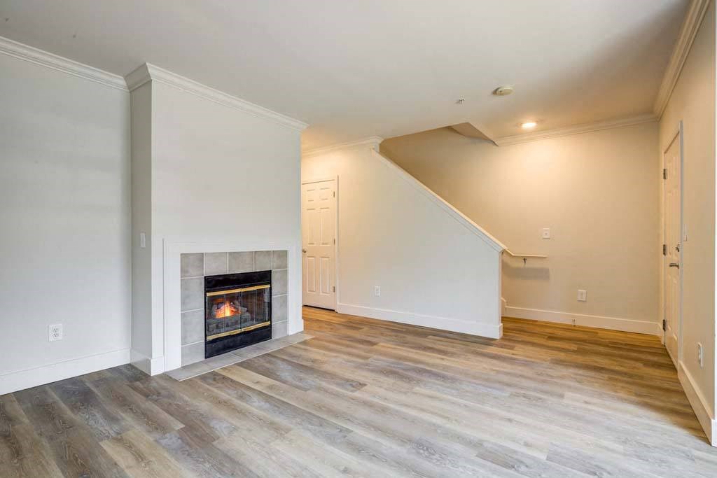 a living room with a fireplace and wooden floors