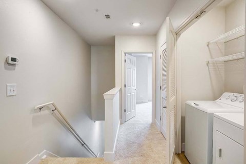 a laundry room with a washer and dryer and a closet