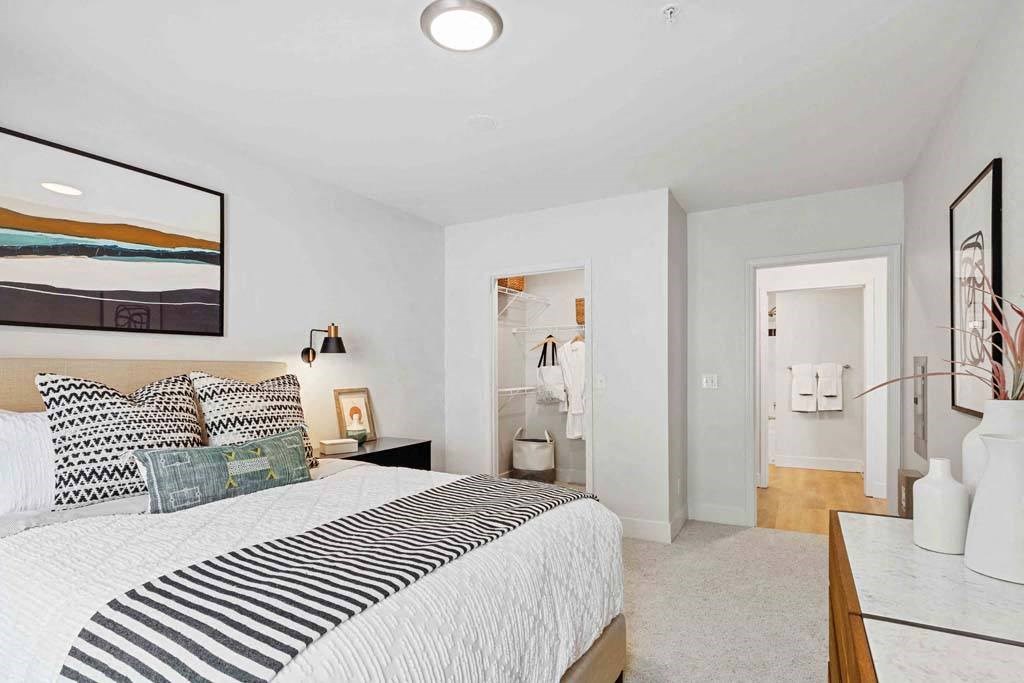 a bedroom with a bed and a bathroom with a sink