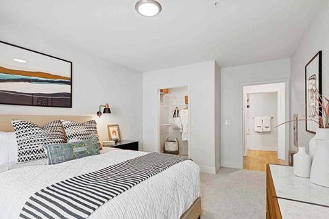 a bedroom with a bed and a bathroom with a sink