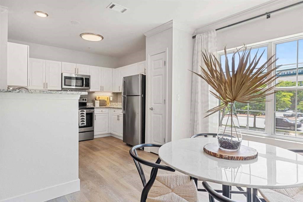 an open kitchen and dining room with a large window