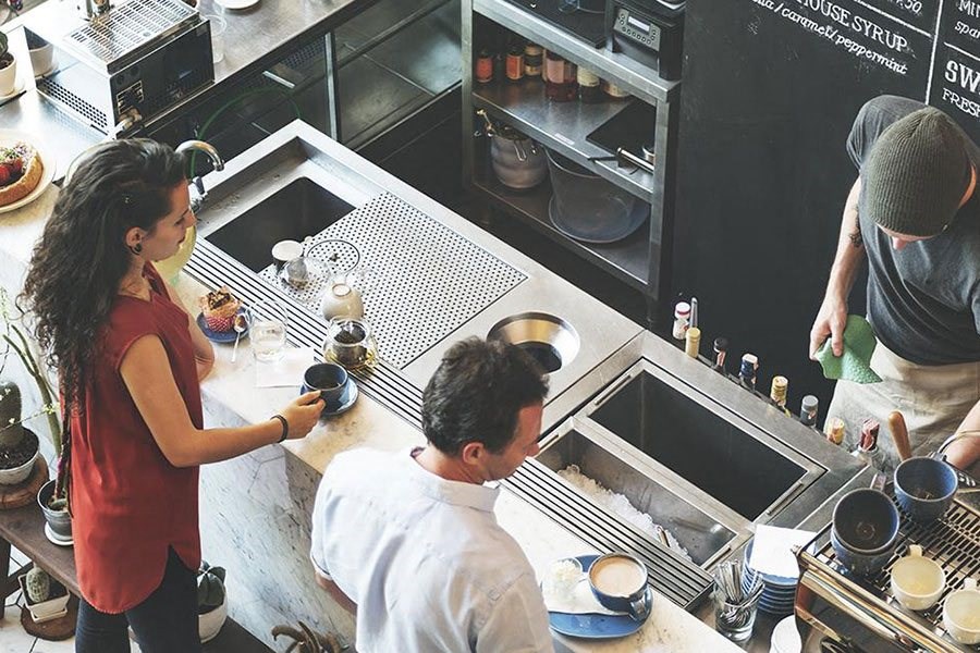 a group of people in a kitchen preparing food