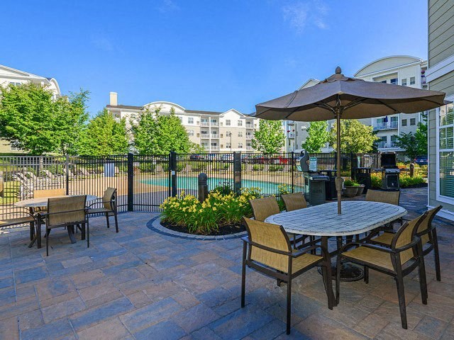 a patio with a table and chairs and an umbrella