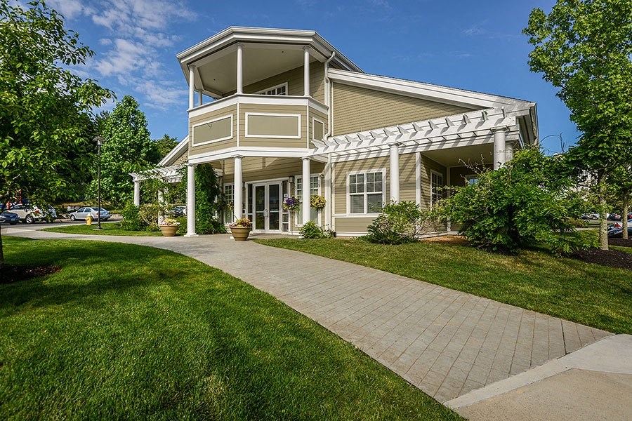 a house with a walkway and lawn in front of it