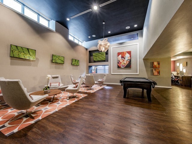 a large living room with chairs and a table