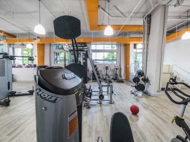 a gym with a lot of machines and weights