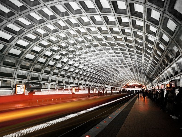 a train is passing through a train station with a tunnel