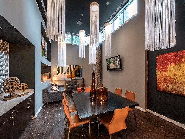 a dining room with a table and chairs and chandeliers