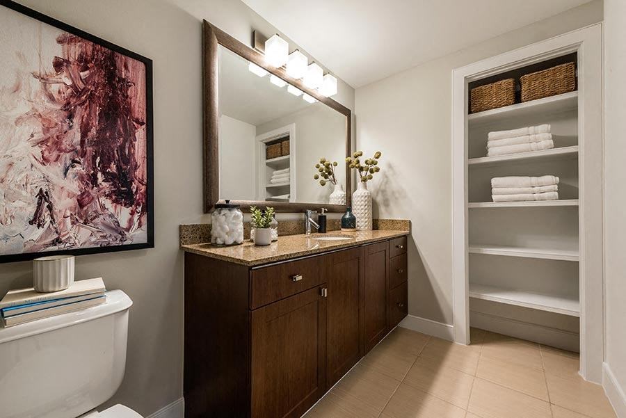 a bathroom with a toilet and a sink and a mirror