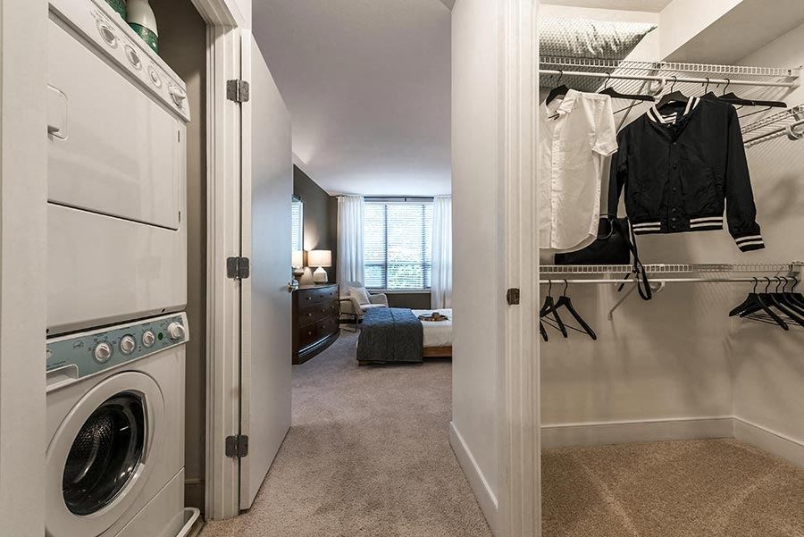 a laundry room with a washer and dryer and a closet