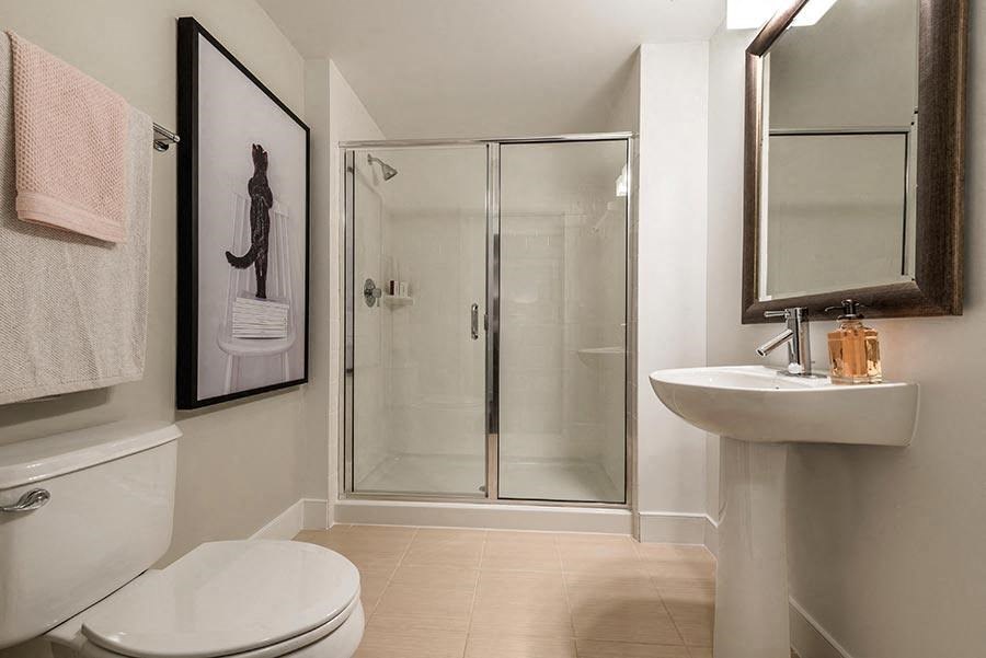 a bathroom with a toilet sink and a shower
