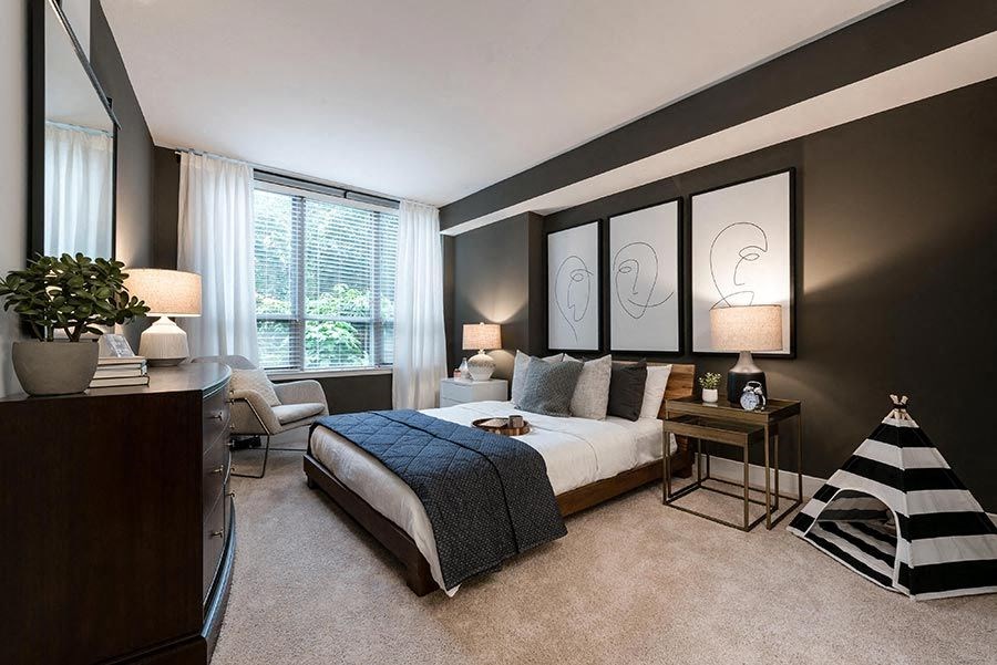 a bedroom with a bed and a desk