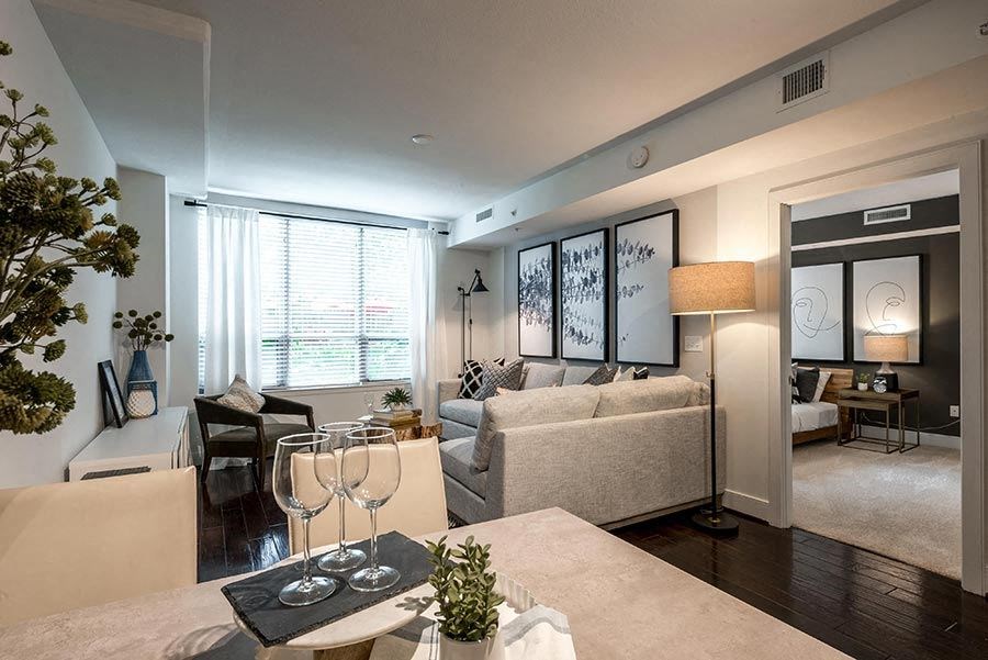 a living room with a couch and a table with wine glasses