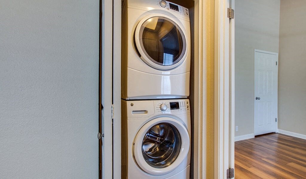 a front loading washer and dryer in a closet