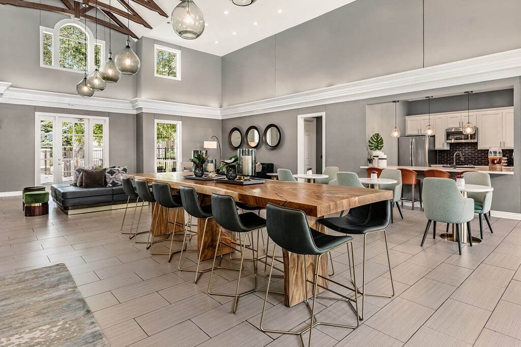 a dining room with a long wooden table and chairs