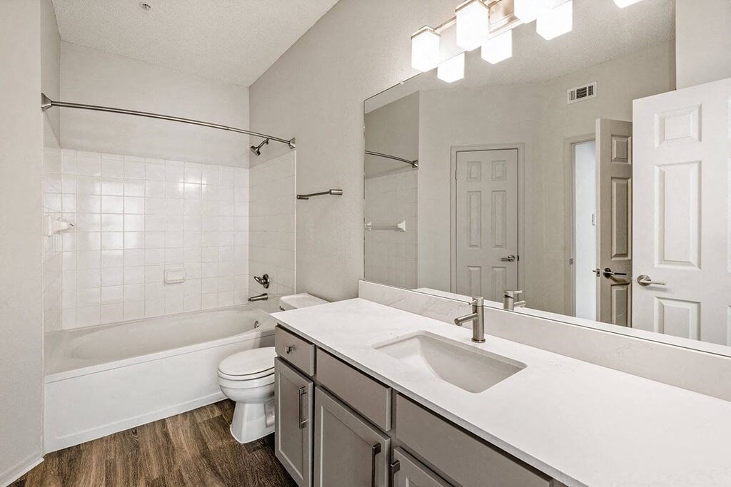 a white bathroom with a sink and a toilet