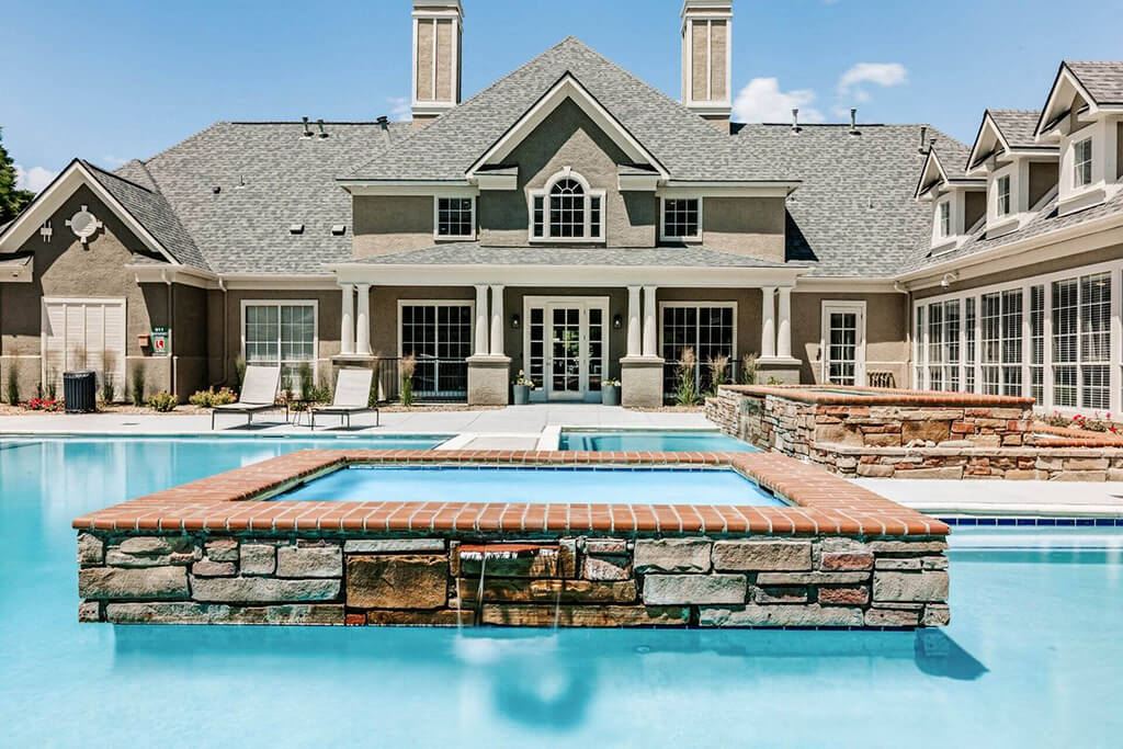 a large swimming pool in front of a house