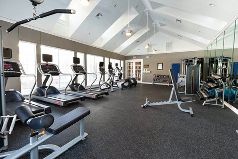 a gym with treadmills and other exercise equipment