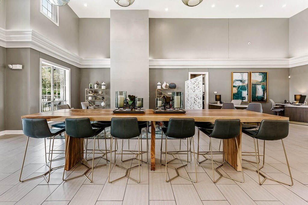 a dining room with a wooden table and chairs