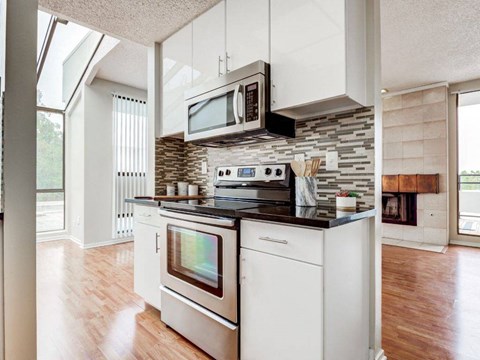 a kitchen with a stove top oven and a microwave