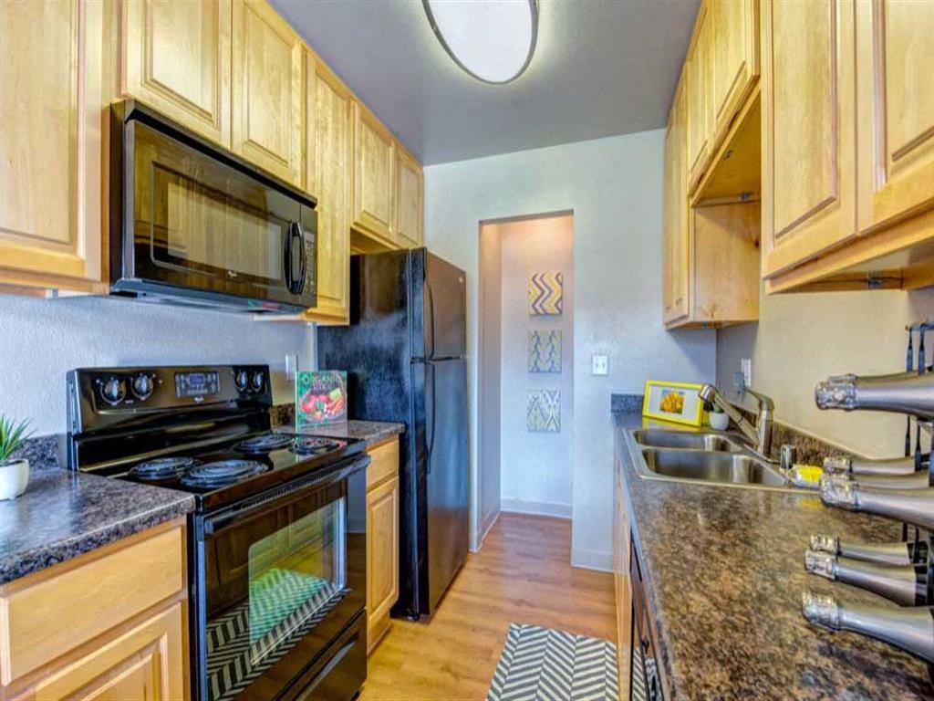 a kitchen with a stove refrigerator and a sink
