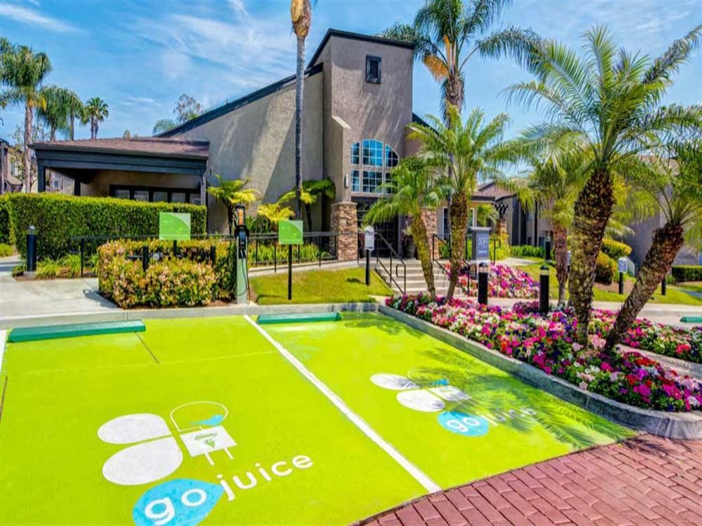 a tennis court is painted on the ground in front of a house