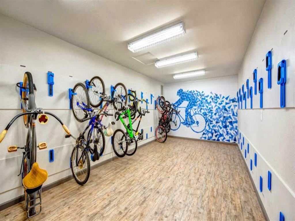 a room with bikes on the wall and a mural on the side